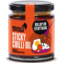 Sticky chilli oil in a glass jar with rich red chili flakes and glossy texture