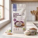 Organic Buckwheat Flour 3kg pouch on a kitchen counter with flour and buckwheat groats