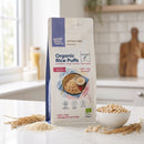 Organic Rice Puffs 250g pouch on a kitchen counter with a breakfast bowl of puffed rice